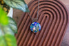 Copper Wire Wrapped Pendant with Swirled Blues and Green Fused Glass